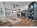 Spacious living room with hardwood floors, large windows, fireplace, and comfortable sectional sofa at 5631 Silver Bluff Ct, Parker, CO 80134