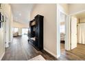 Spacious hallway with hardwood floors, mudroom bench, and views into the living areas at 410 Clover Ct, Frederick, CO 80530