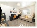 Comfortable home office featuring shiplap accent wall, neutral sofa, and ample natural light at 410 Clover Ct, Frederick, CO 80530