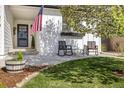 Inviting front porch with rocking chairs, potted plants, and well-maintained landscaping at 410 Clover Ct, Frederick, CO 80530