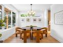 Bright dining room with modern chandelier, stylish decor, and hardwood floors at 2926 S Cherokee St, Englewood, CO 80110