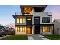 Elegant townhome highlighted by outdoor lighting, roof deck and manicured front lawn at 2926 S Cherokee St, Englewood, CO 80110