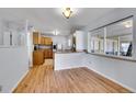 Cozy dining area filled with natural light, showcasing hardwood floors and a view into the adjacent kitchen at 414 S Nelson S St, Lakewood, CO 80226
