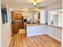 Bright kitchen featuring stainless steel appliances and a breakfast bar, open to the dining area at 414 S Nelson S St, Lakewood, CO 80226