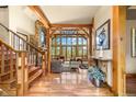 Open concept entryway with hardwood floors and view to living room at 1138 County Road 65, Evergreen, CO 80439