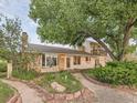 House exterior showcasing landscaping and brick walkway at 9154 Flamingo Way, Littleton, CO 80125