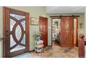 Inviting foyer with a decorative door and charming interior doors at 29857 Park Village Dr, Evergreen, CO 80439