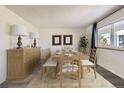 Elegant dining room featuring a hardwood table, chairs, and neutral decor for entertaining guests at 4940 E Donald Ave # 8, Denver, CO 80222