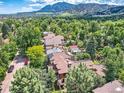 Beautiful aerial view of the home surrounded by lush trees and a mountain backdrop at 3135 11Th St, Boulder, CO 80304
