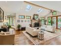 Bright living room with skylights, a stone fireplace, and hardwood floors at 3135 11Th St, Boulder, CO 80304