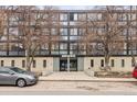 Exterior view of apartment building, showcasing its facade, address, and surrounding trees at 1050 N Corona St # 316, Denver, CO 80218