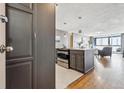 Modern kitchen with stainless steel appliances and an island with seating that opens to the living room at 1050 N Corona St # 316, Denver, CO 80218