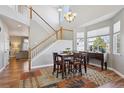 Open concept dining area with large windows and a staircase, creating a bright and airy space at 543 Springvale Rd, Castle Rock, CO 80104