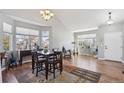 Bright dining room features large windows, hardwood floors, and a stylish chandelier at 543 Springvale Rd, Castle Rock, CO 80104