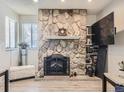 Stone fireplace with a black metal screen at 2630 S Xanadu Way # C, Aurora, CO 80014