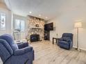 Living room featuring a stone fireplace and hardwood floors at 2630 S Xanadu Way # C, Aurora, CO 80014