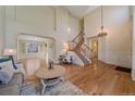 Two-story entryway with hardwood floors, chandelier, and staircase at 13471 Cascade St, Broomfield, CO 80020