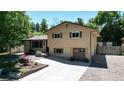Two-story house with a landscaped yard and attached garage at 7722 W 1St Pl, Lakewood, CO 80226