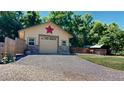 Detached garage with stone accents and adjacent animal enclosure at 7722 W 1St Pl, Lakewood, CO 80226