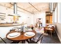 Inviting living space with exposed ductwork, hardwood floors, open layout, and natural light at 1777 E 39Th Ave # 209, Denver, CO 80205