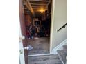 View into the basement with a glimpse of the interior space, shelves and musical equipment and a door at 10001 E Evans Ave # D, Aurora, CO 80247