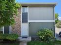 Townhome exterior featuring a stone facade, well-maintained landscaping, and clearly marked address at 10001 E Evans Ave # D, Aurora, CO 80247
