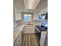 Efficient kitchen layout includes stainless steel appliances, stylish white cabinets and a skylight at 10001 E Evans Ave # D, Aurora, CO 80247