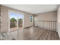 Open living room area with balcony access and staircase at 10001 E Evans Ave # D, Aurora, CO 80247