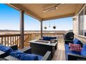 Outdoor deck features a covered seating area with comfortable furniture and neighborhood views at 5998 Berry Ridge Way, Castle Rock, CO 80104