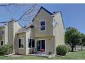 A view of the exterior showing a small patio with furniture and sliding glass doors at 10359 W Fair Ave # F, Littleton, CO 80127
