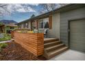 Stylish front porch featuring seating, a wooden accent wall, and fresh landscaping at 4655 Ludlow St, Boulder, CO 80305