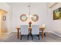 Bright dining area boasts modern mirrors, stylish chairs, and a wooden table at 23110 York Ave, Parker, CO 80138