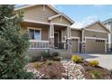 Well-maintained home with an inviting front porch, two-car garage, and front yard landscaping at 2724 Rising Moon Way, Castle Rock, CO 80109