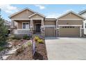 Charming single Gathering home with a two-car garage, landscaped yard, and inviting front porch at 2724 Rising Moon Way, Castle Rock, CO 80109