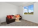 Cozy bedroom with a sofa bed, large window, and carpet flooring at 3037 Lake Helen Blvd, Mead, CO 80542