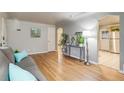 Open living room with hardwood floors, modern console table and an open view to kitchen at 3690 N Hudson St, Denver, CO 80207