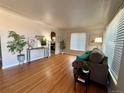 Bright living room with hardwood floors, stylish furnishings, and large windows providing ample natural light at 3690 N Hudson St, Denver, CO 80207