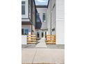 Contemporary townhome entrances with modern fencing and well-maintained landscaping at 5371 W 14Th Ave, Lakewood, CO 80214