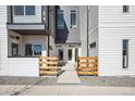 Contemporary townhome entrances with modern fencing and well-maintained landscaping at 5371 W 14Th Ave, Lakewood, CO 80214