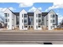 Modern townhome exterior featuring gray and white siding and contemporary architectural design at 5371 W 14Th Ave, Lakewood, CO 80214
