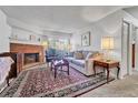 Cozy living room with a brick fireplace, comfortable seating and a large rug at 14226 E 1St Dr # B10, Aurora, CO 80011