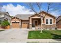 Charming single-Gathering home featuring a manicured lawn, stone accents, and an attached two-car garage at 4553 Red Deer Trl, Broomfield, CO 80020