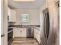 Well-lit kitchen with white cabinets, stainless steel appliances, and granite countertops at 7433 S Quail Cir # 1924, Littleton, CO 80127