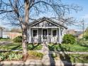 Charming cottage-style home with well-maintained lawn and classic architectural details at 3855 N Cook St, Denver, CO 80205