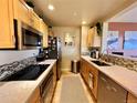 Modern kitchen features stainless appliances, granite countertops and mosaic tile backsplash at 300 W 11Th Ave # 10D, Denver, CO 80204