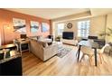 Comfortable living room featuring hardwood floors, a large sectional, and windows for natural light at 300 W 11Th Ave # 10D, Denver, CO 80204
