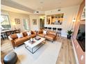 Open-concept living room boasts wood floors, tan couches, and is adjacent to the kitchen at 300 W 11Th Ave # 10D, Denver, CO 80204