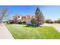 Beautiful multi-story home showcasing lush green lawn and an inviting stone facade at 11374 Xavier Dr # 202, Westminster, CO 80031