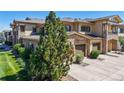 A spacious two-car garage with a beautiful stone exterior and well-maintained landscaping at 11374 Xavier Dr # 202, Westminster, CO 80031