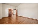 Spacious room featuring hardwood floors and double doors at 26426 E Peakview Dr, Aurora, CO 80016